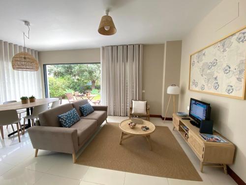 a living room with a couch and a table at Bordal Houses Casa da Areia in Porto Santo