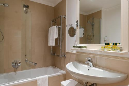 a bathroom with a sink and a tub and a toilet at B&B Hotel Firenze Laurus Al Duomo in Florence
