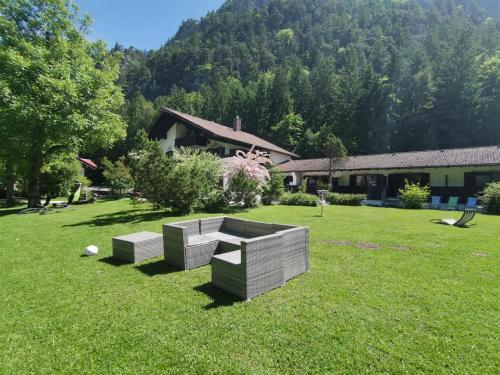 two benches sitting in a field of grass at Pension Almhof Baumgarten in Bad Reichenhall