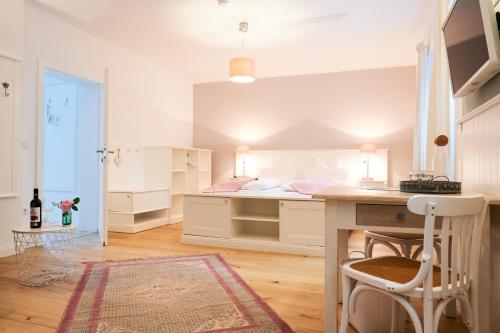 a small bedroom with a bed and a desk at Domizil Gols, Studios Am Anger in Gols