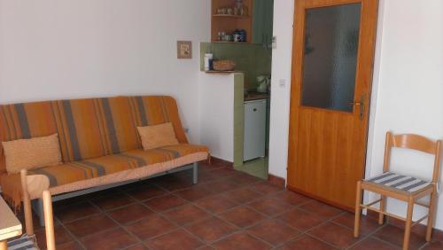 a living room with a couch and a kitchen at Apartments Sofija in Tivat