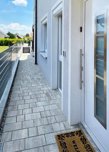 a walkway leading to the front door of a house at Haderer's Home - Bad Vöslau near Vienna in Bad Vöslau