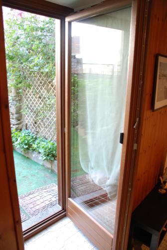 a sliding glass door with a view of a yard at Cà Mia in Nus