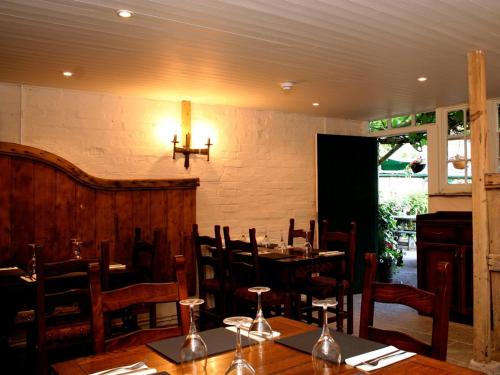 a dining room with tables and chairs in a restaurant at The Lamb Inn in Marlborough