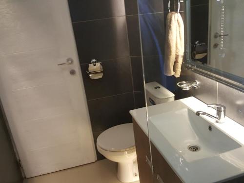 a bathroom with a white toilet and a sink at Katanera 2 in Kraljevo