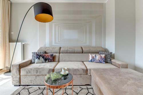 a living room with a couch and a table at Old Town – OldNova by Welcome Apartment in Gdańsk