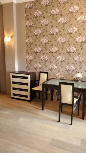 a dining room with a table and two chairs at Arcadia Palace Apartments with Sea View in Odesa