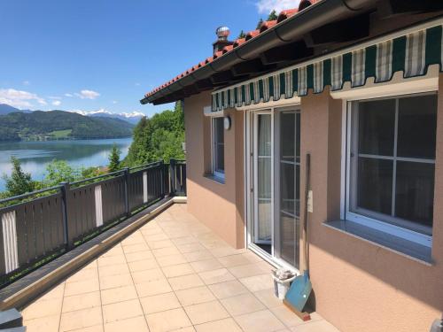 a balcony of a house with a view of a lake at Seeblick in Döbriach