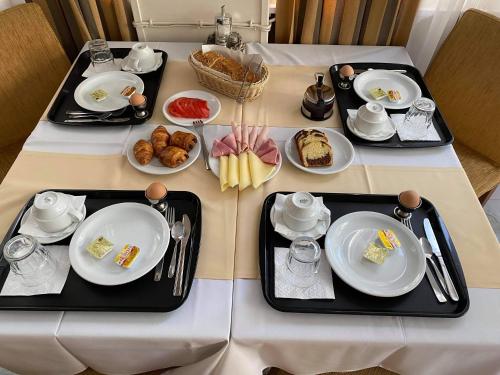 a table with plates of food on it at Adams Hotel in Athens