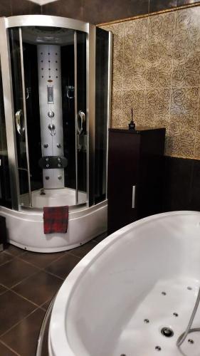 a large white bath tub in a bathroom at Arcadia Palace Apartments with Sea View in Odesa