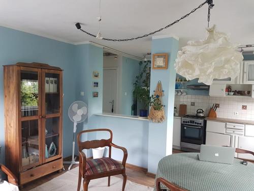 a kitchen with a table and a chair in a room at Bajka in Gdańsk