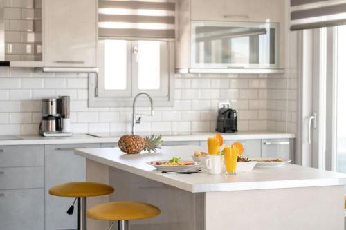 a kitchen with a counter with food and fruits on it at Villa Makrilis in Karterados
