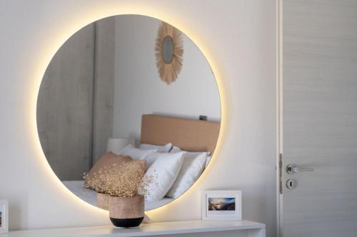 a bedroom with a circular mirror over a bed at Villa Makrilis in Karterados
