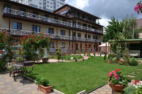a hotel with a garden in front of it at Апартаменти Маяк in Odesa