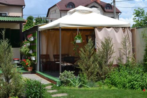 a garden with a white umbrella in a yard at Апартаменти Маяк in Odesa