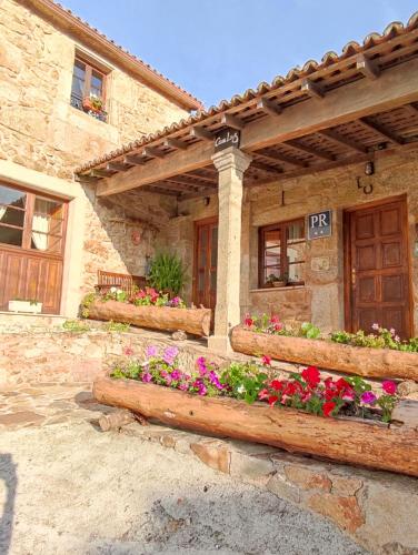 a house with flower boxes on the front of it at Casa Luz in Lires