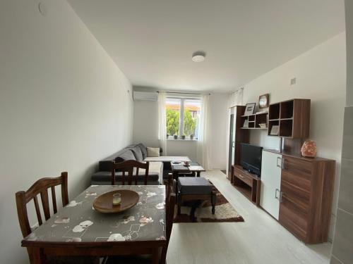 a living room with a table and a dining room at Apartmani JOVANOVIC Sokobanja in Soko Banja