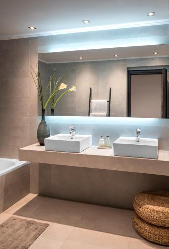 a bathroom with two sinks and a large mirror at Villa Soligia Blue in Pefkali