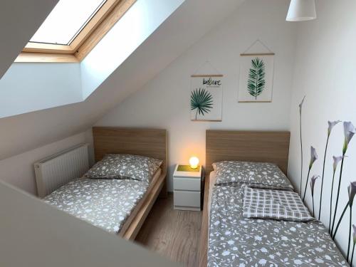 two twin beds in a room with a window at Schöne und Helle Deutsch-Wagram Wohnungen in Deutsch-Wagram