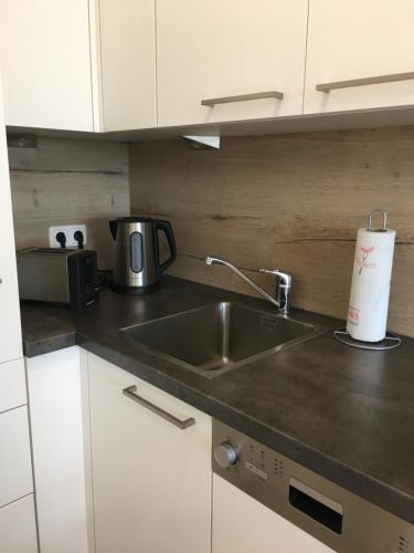 a kitchen with a sink and a coffee maker at Schöne und Helle Deutsch-Wagram Wohnungen in Deutsch-Wagram