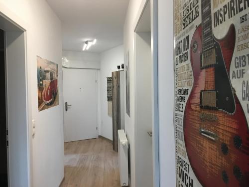 a hallway with a guitar mural on the wall at Schöne und Helle Deutsch-Wagram Wohnungen in Deutsch-Wagram