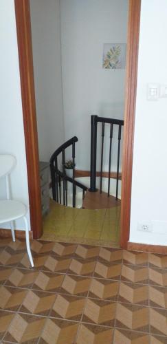 a room with a table and two chairs and a floor at La Casetta nel cuore del Parco in Locana