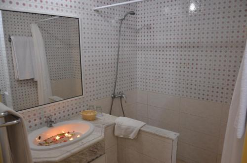 a bathroom with a sink and a mirror at Thapsus Beach Resort in Mahdia