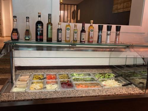 a buffet with different types of food and bottles of wine at Hotel-Fritz in Valwig