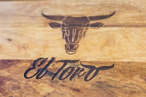 a wooden table with a drawing of a bull on it at Villmergen Swiss Quality Hotel in Villmergen