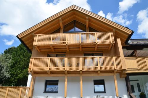 a house with wooden balconies on top of it at Haus Nick, Appartementhaus in Sankt Anton am Arlberg