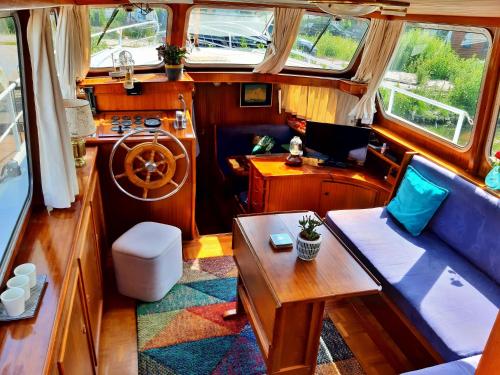 a room with a couch and a table in a boat at Motor Yacht Amstelle in Amsterdam