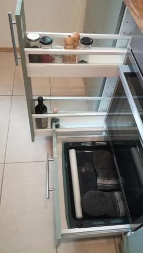 a cabinet with a glass door with a chair in it at Anna's Cosy Apartment in Illmitz