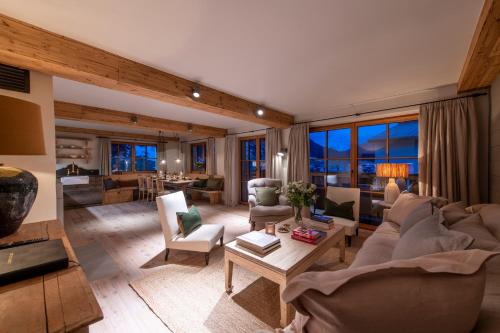 a living room with a couch and a table at Brunnenhof Luxury Apartments in Lech am Arlberg