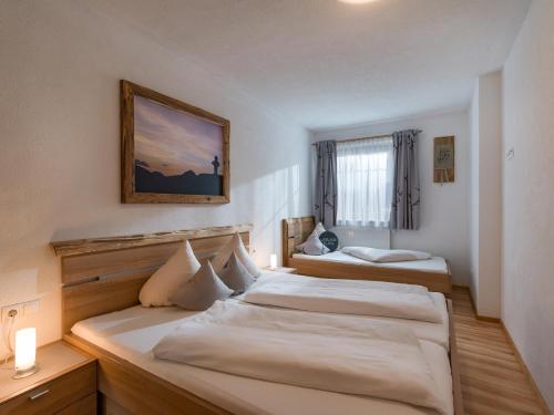 a bedroom with two beds and a picture on the wall at Ferienwohnung Eberharter in Hart im Zillertal