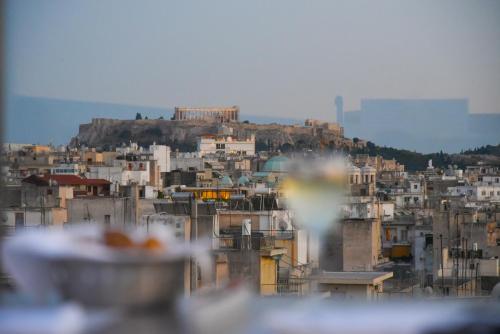 a view of a city with buildings on a hill at Novotel Athens in Athens