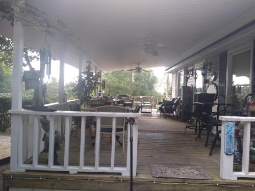 a front porch of a house with a white railing at Serenity Hill b&b in Sloans Crossing