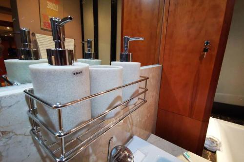 a towel rack with four rolls of toilet paper at 1507-Amazing views & Unique Joburg CBD Luxury in Johannesburg