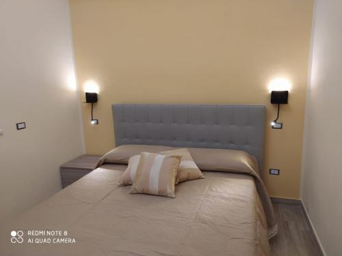 a bedroom with a bed with two pillows on it at Luxury House in Cirò Marina