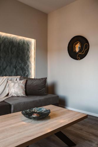 a living room with a couch and a coffee table at Alto Suite (Cielo suites) in Kavala