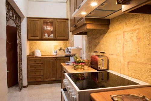 a kitchen with a sink and a counter top at Tal-Karmnu Entire house with private heated pool and jacuzzi in Kirkop