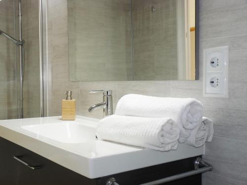 a bathroom with a sink with towels on it at Apartamento Dayok Costa Barcelona in Malgrat de Mar