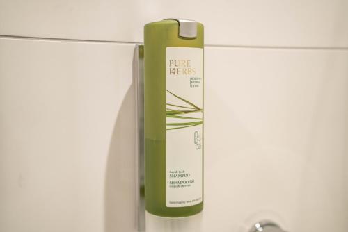 a bottle of pure blacks hanging on a wall at CityApartments Residence klimatisiert in Friedrichshafen