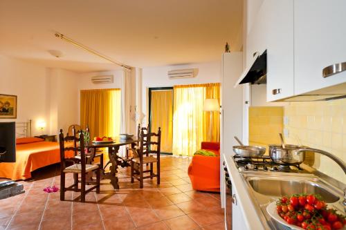 a kitchen and living room with a sink and a table at Residence Degli Agrumi in Taormina
