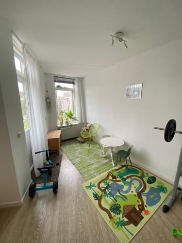 a living room with a table and a rug at Vakantiewoning in Middelburg Zeeland in Middelburg