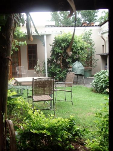two chairs and a table in a yard at Duvet & Crumpets in Pietermaritzburg