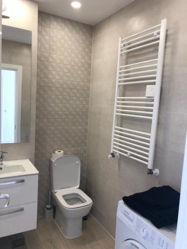 a bathroom with a toilet and a sink at Hils Pallady Bucharest apartments in Bucharest