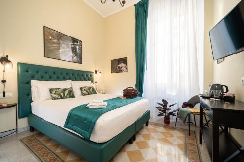 a bedroom with a large bed with a green headboard at Sweet Home Pigneto Guest House in Rome