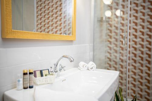 a bathroom with a white sink and a mirror at Sweet Home Pigneto Guest House in Rome