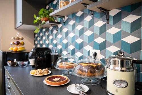 a kitchen counter with some food on a counter top at Sweet Home Pigneto Guest House in Rome