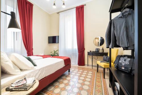 a hotel room with a bed with red curtains at Sweet Home Pigneto Guest House in Rome